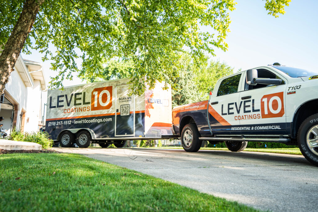 Branded Level 10 truck and trailer parked elegantly on a residential driveway, showcasing the company's professional presence.