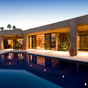 Stylish rental home with pool and epoxied concrete surroundings.
