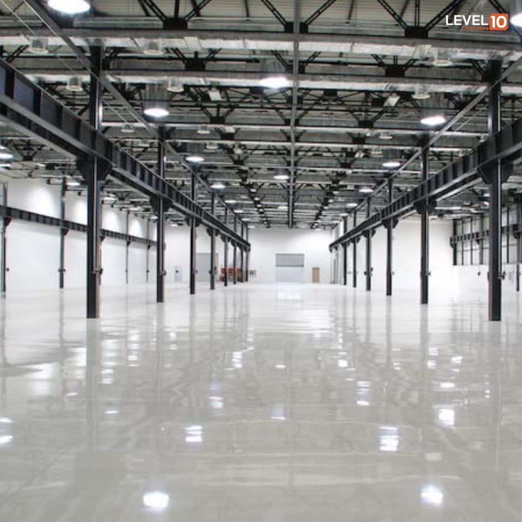 Stunning epoxy floor by Level 10 Coatings in a spacious warehouse, showcasing durability and style.