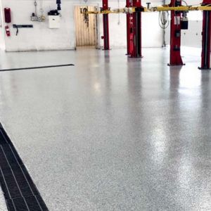 Robust epoxied flooring in a busy automotive service center ensuring durability and ease of maintenance.