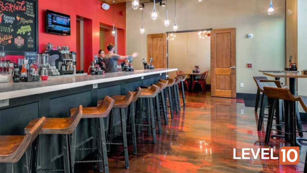 Sleek modern bar interior featuring a striking red epoxy floor that enhances the ambiance