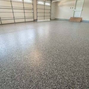 Finished epoxy flake floor in a residential garage by Level 10 Coatings.