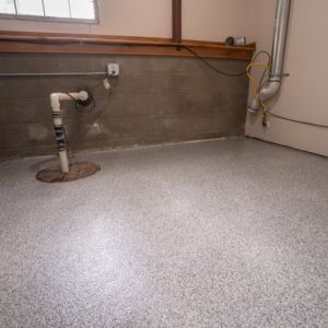 Epoxy flake floor enhancing a home laundry room, installed by Level 10 Coatings