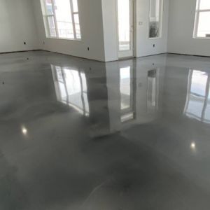 Dark gray polished concrete floor in a modern home setting.