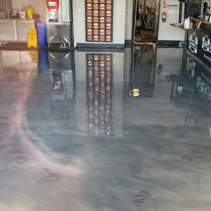 Dark gray polished concrete floor in a trendy burger restaurant.