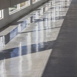 Sleek polished concrete floor reflecting overhead lights.