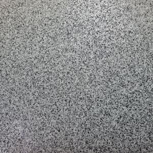 Detailed view of grey and black epoxy flake blend on a floor surface.