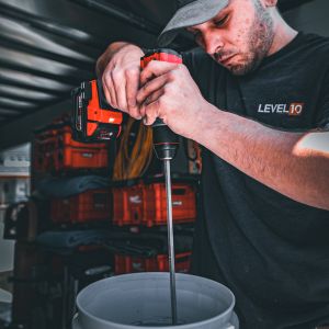 Level 10 Coatings employee preparing epoxy mix for flake flooring.
